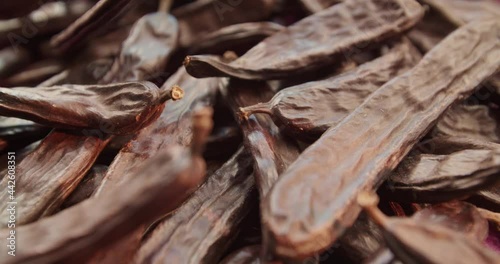 Carob dried fruit close-up. Advertising of food does not contain caffeine, wholesome food and drinks from the carob