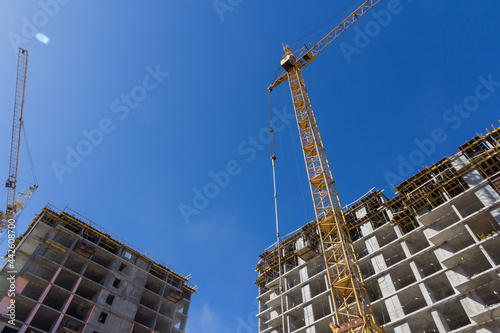 Construction crane at a construction site. Mechanisms for lifting construction materials. Lifting construction equipment