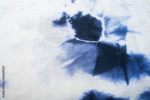 White fabric with blue tie dye stain. Background or texture