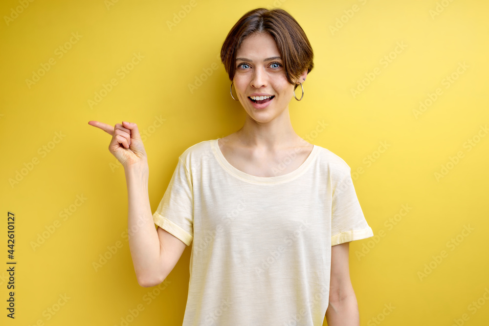 positive adult woman pointing finger at side copy space for advertisement, young female in casual wear advising, showing at something positive adult woman pointing finger at side copy space for advertisement, young female in casual wear advising, showing at something