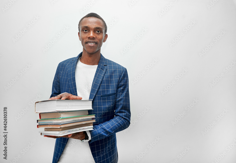 A young man with books in his hands on a white background A young man with books in his hands on a white background