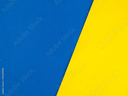 Blue and yellow paper background, divided into two halves, textured, free space
