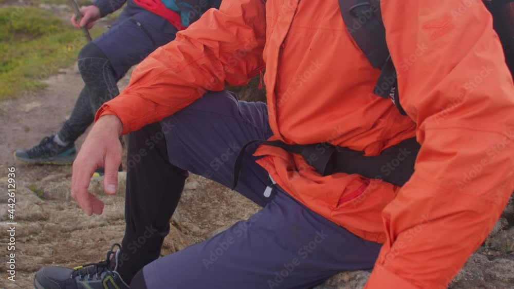 Lost in the mountains. Tourist instructor and assistant sit on a stone. They are tired of awaiting evacuation from the top of the mountain. Camera movement. Lost in the mountains. Tourist instructor and assistant sit on a stone. They are tired of awaiting evacuation from the top of the mountain. Camera movement.
