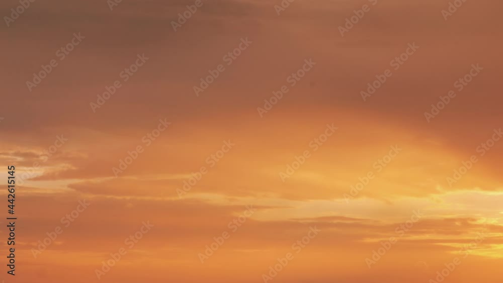 Sunset Cloudy Sky With Gently Clouds. Sunset Sky Natural Background. Sunset Time Lapse Time-Lapse In Yellow, Orange Colors. Day To Evening Transition Sunset Cloudy Sky With Gently Clouds. Sunset Sky Natural Background. Sunset Time Lapse Time-Lapse In Yellow, Orange Colors. Day To Evening Transition