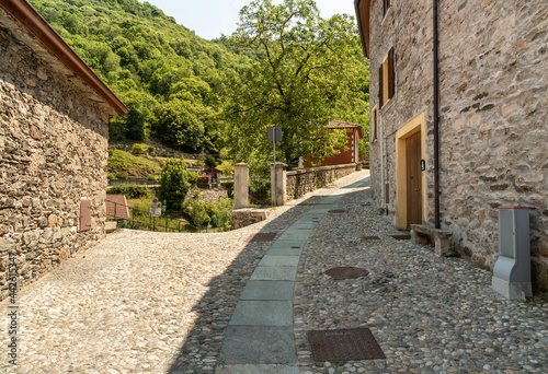 Fototapeta Naklejka Na Ścianę i Meble -  Narrow streets with stone houses in the small mountain village of Bassola, hamlet of Armeno above Lake Orta in the province of Novara, Piedmont, Italy