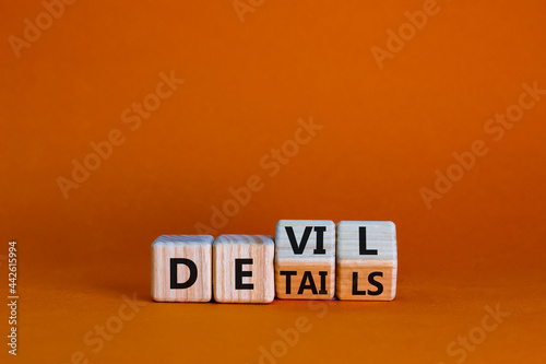 Devil in the details symbol. Turned cubes and changed the word 'details' to 'devil'. Beautiful orange background. Business and devil in the details concept. Copy space. photo