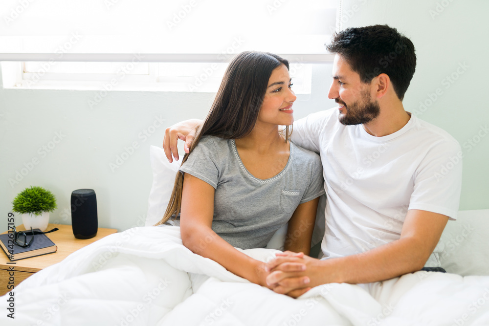 Romantic couple having a nice conversation in bed Romantic couple having a nice conversation in bed