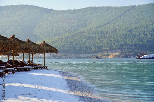 White snow Beach and tropical sea in sunrise, Bodrum, Turkey. No people. Banner Lux vacation. Clear turquoise ocean lagoon and Deep Blue cloudy sky after. Expectation to success dreams, Travel and