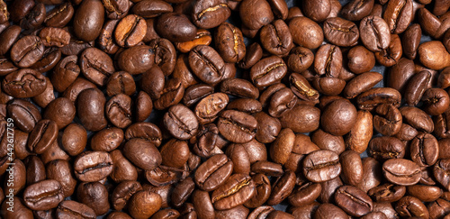 Fresh brown roasted coffee beans as a background