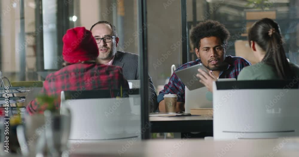 Millennial hipster employees discussing marketing strategies with diverse multiethnic team on brainstorming session in office. Creative workers on workshop 4k footage Millennial hipster employees discussing marketing strategies with diverse multiethnic team on brainstorming session in office. Creative workers on workshop 4k footage