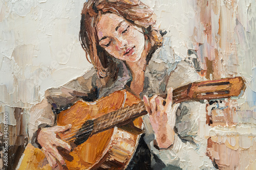 .The girl plays the guitar. Music lessons. Oil painting on canvas. photo