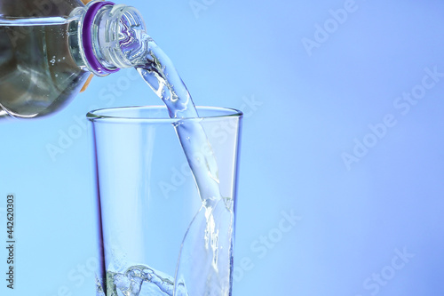 pouring water into a glass close up. filling a glass with clean water from a bottle