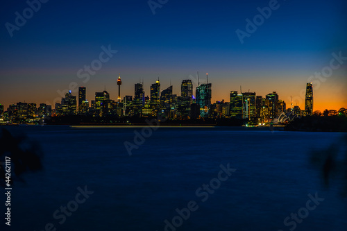 Sydney city skyline at night from across the harbour.
