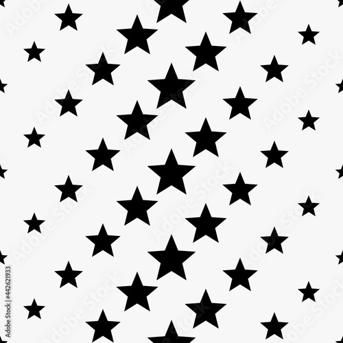 Seamless stars pattern. Vector black stars wallpaper. Large and small stars.