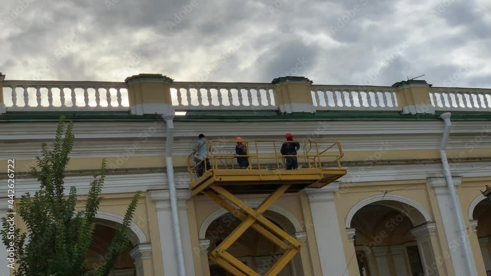 Workers restore the facade of an ancient mansion St. Peter Russia Workers restore the facade of an ancient mansion St. Peter Russia
