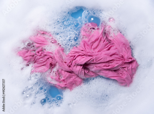 Wet color clothes with white foam Soak before washing top view