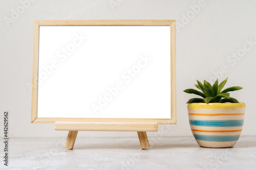 Standing picture frame with small potted plants