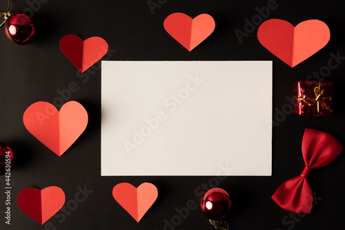 White paper and red heart paper pasted on a black background. © Johnstocker