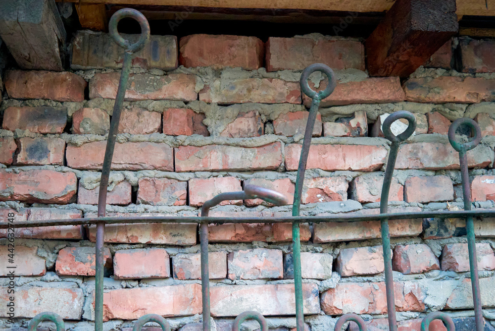 an old brick wall reinforced with iron bars