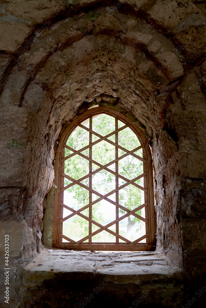 a window in a castle with stone walls