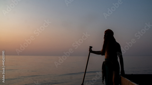 Silhouette of a pirate on the boat sailing into the lake at sunset time in Ontario  Canada.