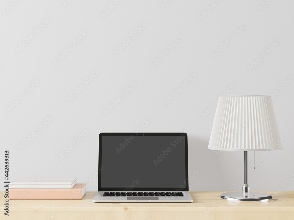 A working room with a laptop with a lamp placed on the table. A working room with a laptop with a lamp placed on the table.