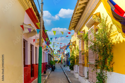 Colombia, Scenic colorful streets of Cartagena in historic Getsemani district near Walled City, Ciudad Amurallada, a UNESCO world heritage site. photo
