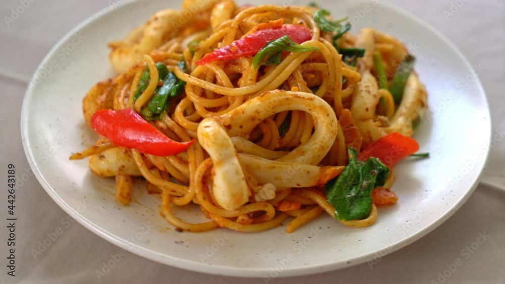stir-fried spaghetti with salted egg and squid - fusion food style stir-fried spaghetti with salted egg and squid - fusion food style
