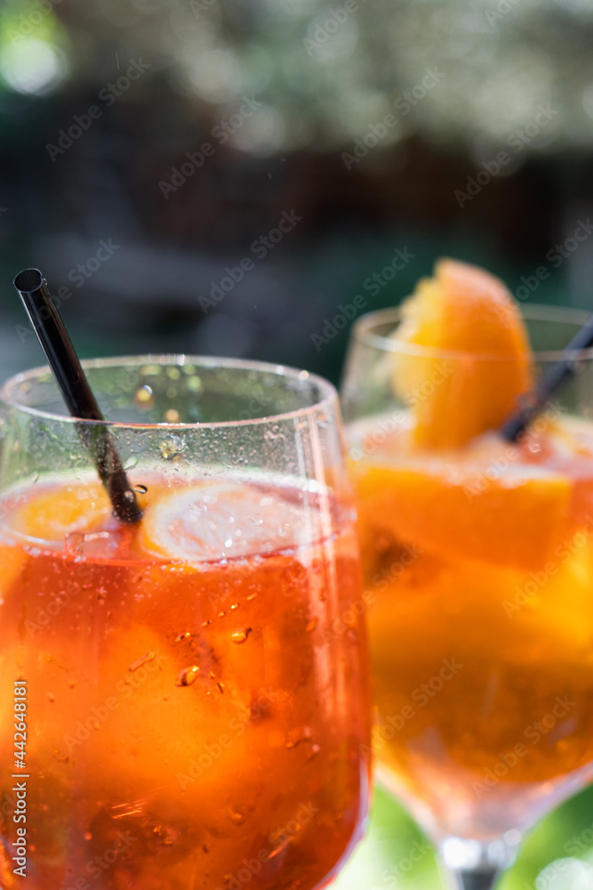 Summer cocktails with orange, lime and mint. Alcoholic cocktail in a tall glass on a stem. Gin tonic long drink. Summer cocktails with orange, lime and mint. Alcoholic cocktail in a tall glass on a stem. Gin tonic long drink.