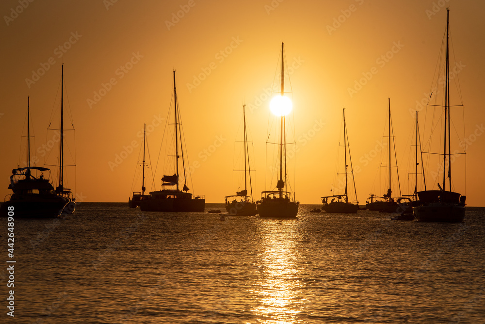 Yachts in Cala Saona Beach in Formentera in Spain in summer 2021.