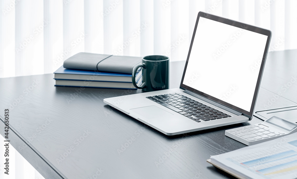 Mockup blank screen laptop computer on wooden table in modern office room. Mockup blank screen laptop computer on wooden table in modern office room.