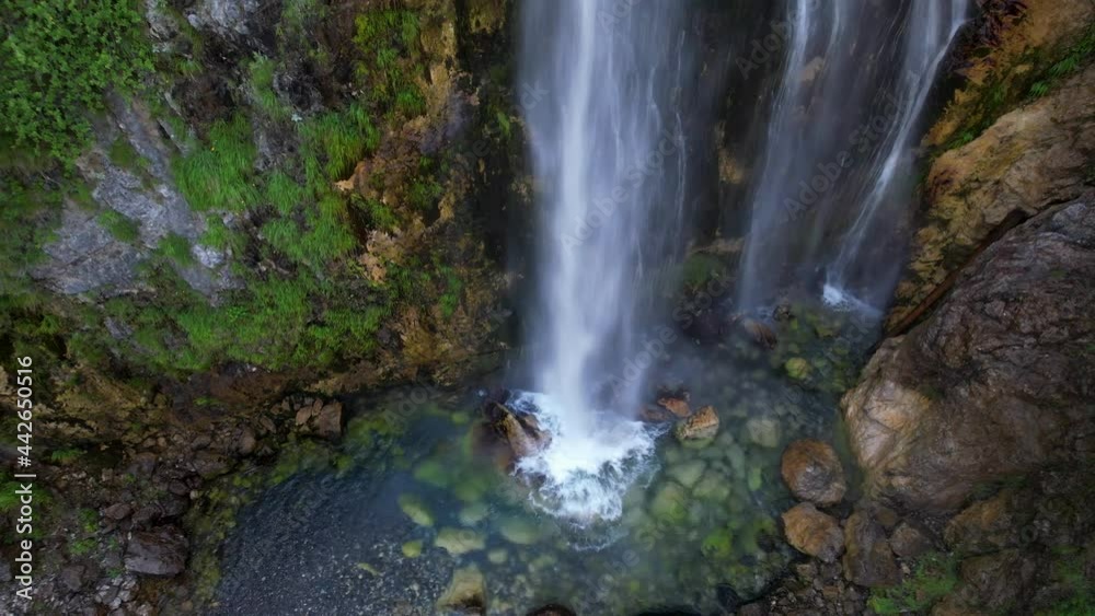 Colorful waterfall landscape with green trees and clean water splashing on cliffs in Albania Colorful waterfall landscape with green trees and clean water splashing on cliffs in Albania