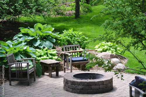 Fotografija a fire pit in an idyllic, quiet backyard