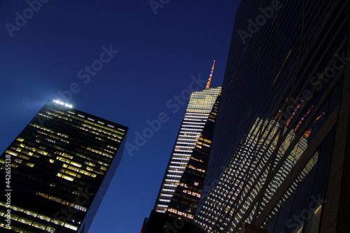 New York, NY - March 27, 2014: 42nd Street view of a building at night reflecting in the city