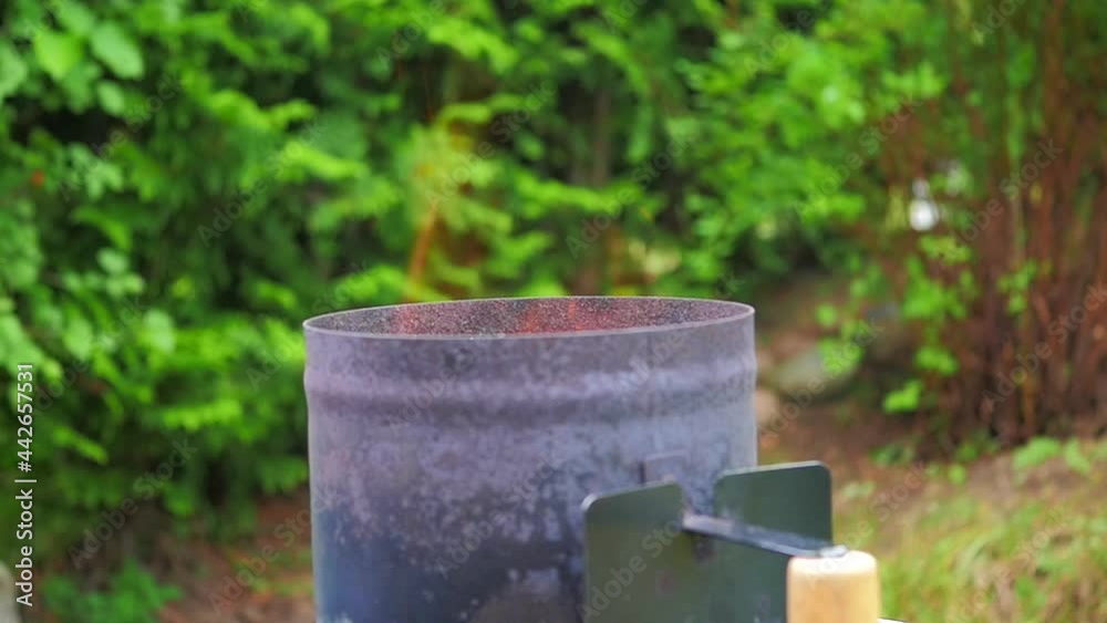 Sparks and flames in super slow motion, from charcoals inside a heating