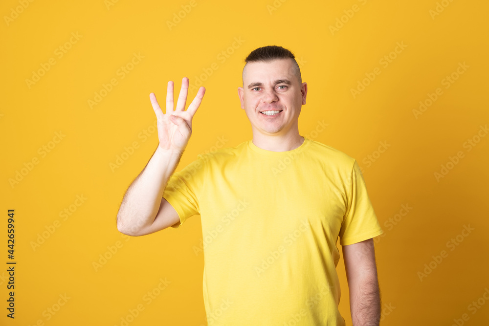 Young handsome man smiling showing four finger of hands. Number four. Young handsome man smiling showing four finger of hands. Number four.