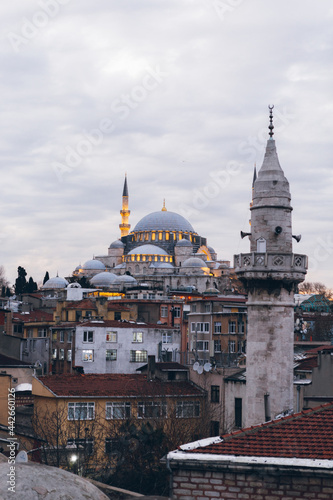 Old tower in residential district near mosque photo