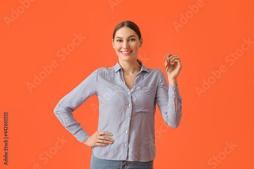 Happy young woman with key ...