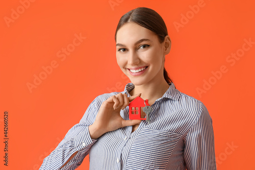 Happy young woman with key ...