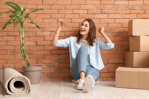 Happy young woman with key ...