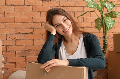 Happy young woman with key ...