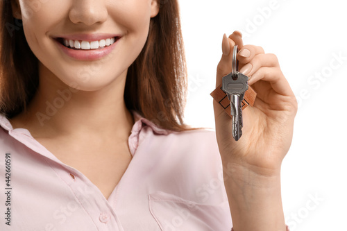 Happy young woman with key ...