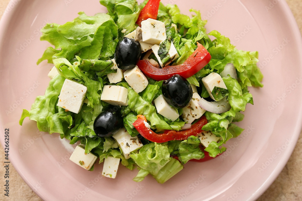 Plate with fresh Greek salad on color background, closeup Plate with fresh Greek salad on color background, closeup