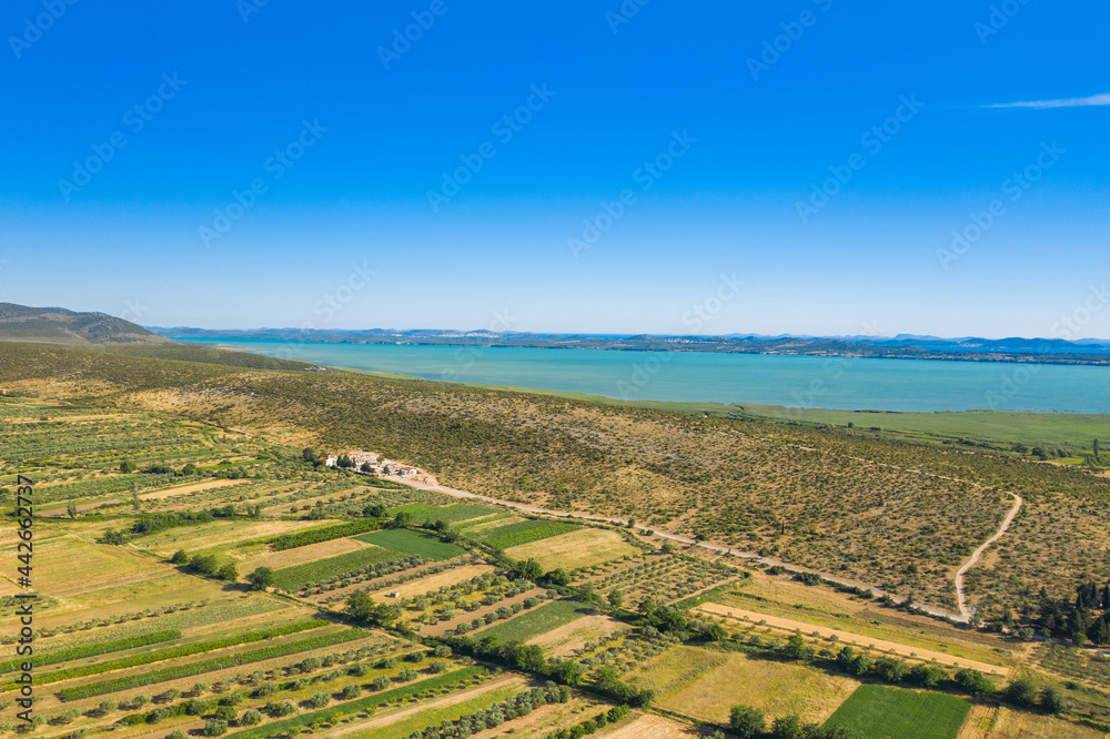 Aerial view of countryside landscape, Vransko lake and agriculture fields, Dalmatia, Croatia