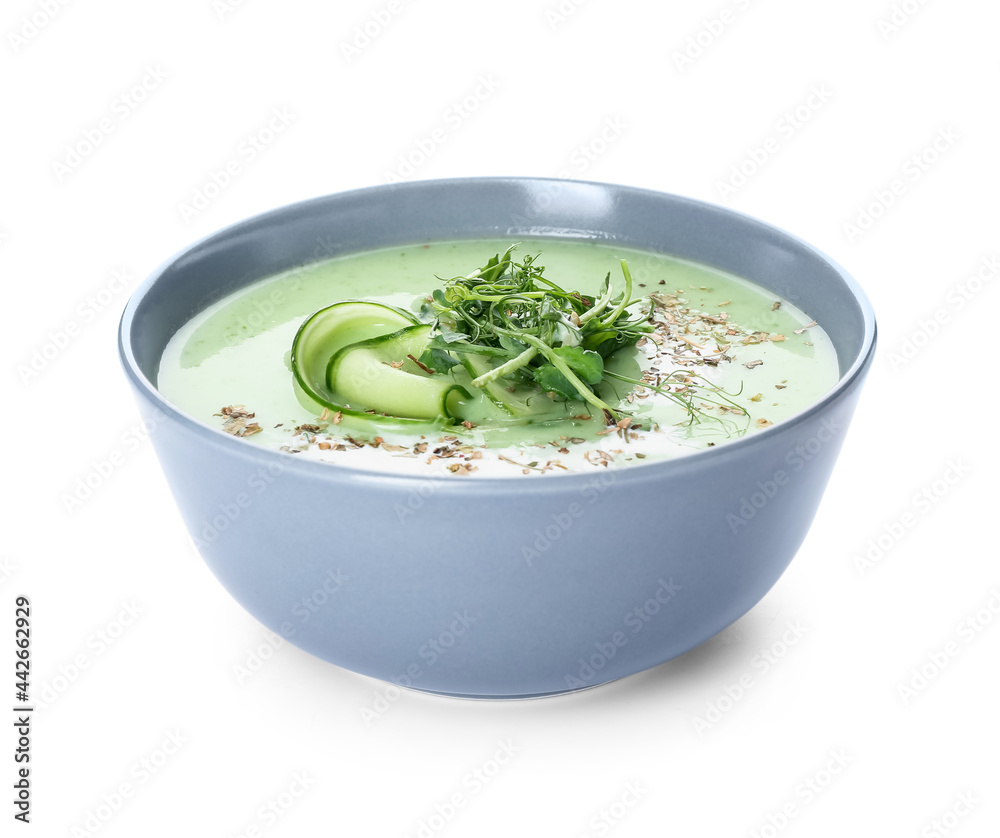 Bowl with green gazpacho on white background