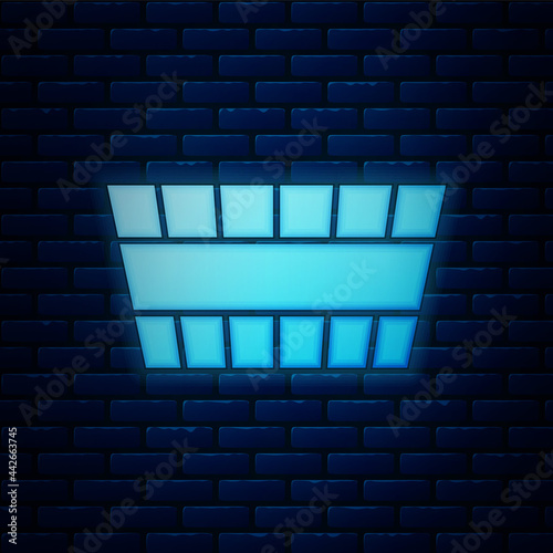 Glowing neon Sauna bucket icon isolated on brick wall background. Vector