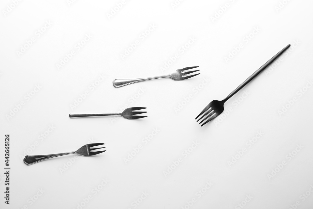 Different forks on white background. Concept of racism Different forks on white background. Concept of racism