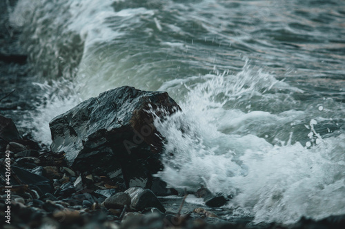 waves crash on stones in the sea 