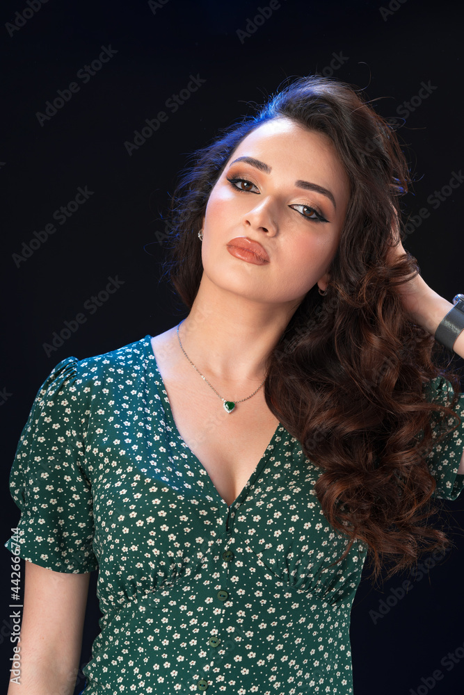 Studio portrait of a young beautiful brunette woman against black background Studio portrait of a young beautiful brunette woman against black background