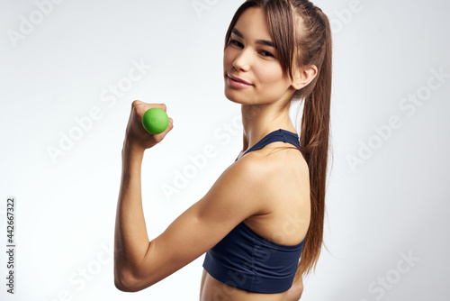 sports woman holding green dumbbells fitness motivation